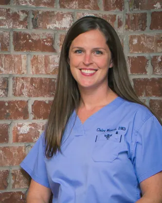 Dr. Claire Mayatte smiling in blue scrubs