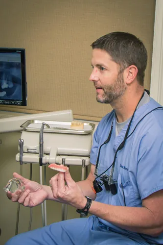 Dr. Shaun Mayatte talking with a patient in a treatment room